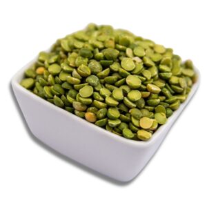 A white bowl filled with green split peas, showcasing their vibrant color and texture.