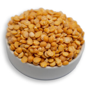 A white bowl filled with dry yellow split peas, showcasing their smooth texture and deep yellow color.